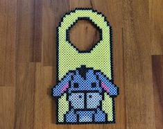 a cell phone case made out of perler beads with an image of a robot on it