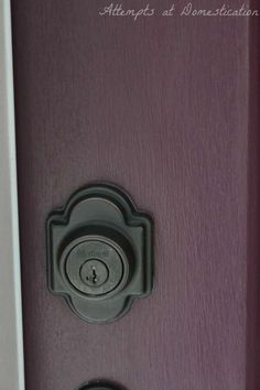 an open door with two knobs on the front and side of it that is painted purple