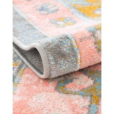 a colorful rug with an intricate design on the bottom, and multicolored carpeting