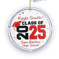 a round ornament hanging from a christmas tree with the class of 205 on it