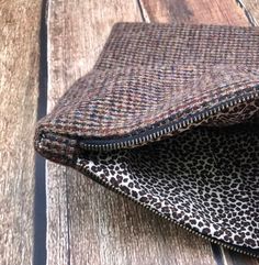 This is a beautiful, handmade fold over clutch bag that is ready to ship. This bag will take you from day to night and is a one of a kind, unique clutch. The exterior of the bag is made from men's suiting fabric in black, shades of brown, tan, truly a traditional tweed. The zipper is an antique style brass zipper that compliments the style of the bag. The interior is made from a brown animal print cotton that coordinates with the exterior of the bag and makes a playful statement. This is a timel Luxury Tweed Evening Bag, Black Rectangular Tweed Shoulder Bag, Toddler Hats Boy, Fall Tweed Shoulder Bag, Rectangular Shape, Luxury Tweed Rectangular Bag, Men's Suiting, Brown Clutch With Gold-tone Hardware, Unique Clutch, Fold Over Clutch