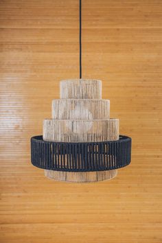 a black and white chandelier hanging from a wooden ceiling