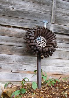 a metal pole with a flower made out of wine corks