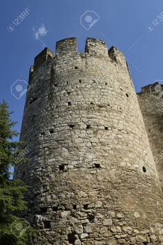 an old stone castle with holes in the wall and trees around it stock photo - 959