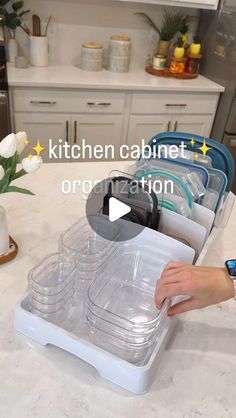 the kitchen cabinet organization system is organized with clear plastic trays and lids for storage