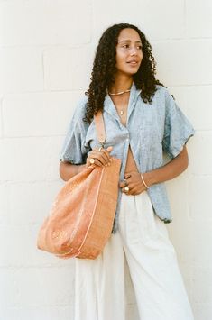 DIMENSION Oversized tote, dimensions vary COLOR Peach, orangey-pink MATERIAL Cactus silk, cotton lining, natural leather strap Orange Summer Tote Shoulder Bag, Orange Bucket Bag For Summer Travel, Orange Tote Shoulder Bag For Summer, Orange Bucket Bag With Leather Handles, Casual Orange Tote Bucket Bag, Summer Orange Handwoven Shoulder Bag, Summer Handwoven Orange Shoulder Bag, Orange Bucket Bag For Beach, Chic Orange Bucket Bag Tote