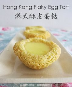 three desserts sitting on top of a white plate with chinese writing in the background