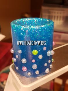 there is a blue candle that has bubbles on it and the words with love always works