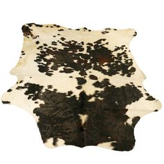 a black and white cowhide rug on a white background