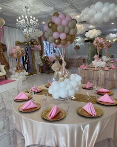 a table set up for a party with pink and white balloons, gold chargers, and teddy bears