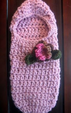 a crocheted bag with a flower on it