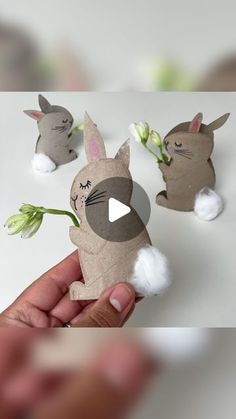 someone is holding up some paper animals with flowers