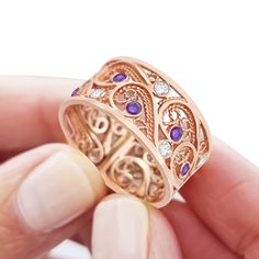 "This one of a kind 14k rose gold ring features the beautiful unique traditional yemenite filigree art. The delicate filigree art was created in the traditional yemenite filigree style, which has been practiced in the artist's family for generations. The artist's family originally designed fine jewelry for the yemenite royal family. The piece is enhanced by the magnificent sparkle of the white lavender and purple amethyst gems spread artistically throughout the filigree work. This unique piece o Filigree Wedding Ring, Filigree Ring Gold, Handmade Wedding Rings, White Lavender, Wedding Ring For Her, Amethyst Gem, 14k Rose Gold Ring, Custom Ring Designs, Custom Ring