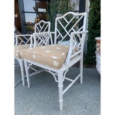 two white wicker chairs with tan cushions