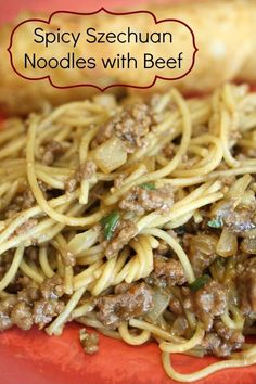 spaghetti with meat and vegetables on a red plate