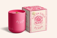 a pink candle in front of a box