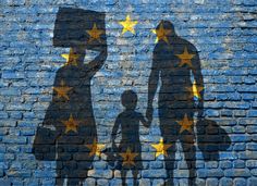 the shadow of two people and a child against a brick wall with stars painted on it