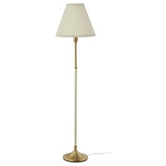 a floor lamp with a white shade on the base and a light bulb attached to it