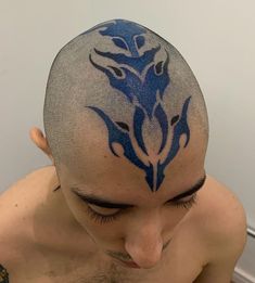 a man with a blue tattoo on his head