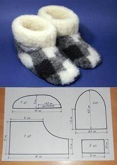 a pair of slippers sitting on top of a table next to a cut out pattern