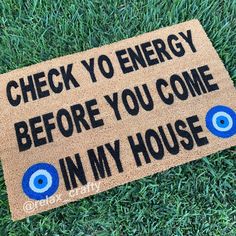 a door mat that says check yo energy before you come in my house on the grass