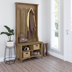 a wooden bench with baskets underneath it next to a coat rack