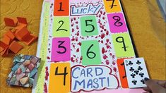 a child's hand is holding up a card that has been made into a board game