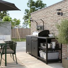 an outdoor bbq and patio furniture set up on the side of a brick wall