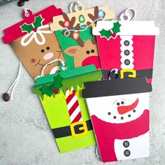 four christmas gift tags on a table