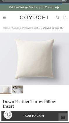 a white pillow sitting on top of a bed