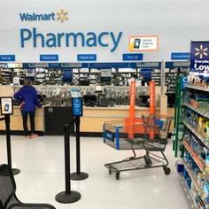 a walmart pharmacy with people shopping in it