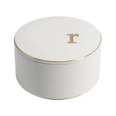 a white and gold container with the letter r on it's lid, sitting in front of a white background