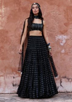 Editor's Note Make a bold statement in this black sequin and glassbeads embroidered blouse paired with a georgette sari gown. This ensemble effortlessly combines traditional and contemporary elements, making it perfect for special occasions and evening events. Fabric: Georgette, rawsilk and net Color: Black Component: Skirt, blouse and dupatta Occasion: Festive Disclaimer: Product color may slightly vary due to photographic lighting sources or your monitor setting. Care: Dry clean only About the Sari Gown, Black Lehenga Choli, Blouse Yoke, Black Sequin Skirt, Cotton Lehenga, Black Lehenga, Frill Skirt, Contemporary Elements, Skirt Blouse