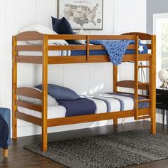 the bunk bed is made with wood and has two sets of mattresses on it