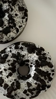 two donuts covered in oreo cookies and white frosting