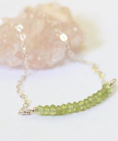 A sparkling peridot gemstone bead bar bracelet. The birthstone for August is this colorful green gemstone, with your choice of sterling silver or gold filled material. A great gift for an August birthday. Wear as a dainty everyday minimal bracelet or paired with other layered bracelets. Peridot Faceted Beads Jewelry Gift, Minimal Bracelet, Peridot Bracelet, Bead Bar, Peridot Jewelry, Semi Precious Beads, August Birthstone Jewelry, Peridot Gemstone, Bar Bracelets