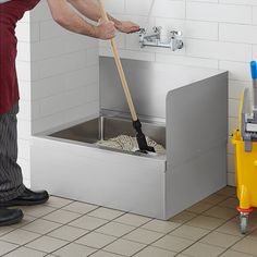 a man is cleaning the floor with a mop