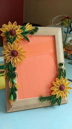 a wooden frame decorated with paper flowers