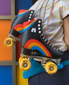 a person wearing roller skates with colorful wheels on their back and one foot in the air