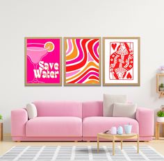 a living room with pink couches and paintings on the wall