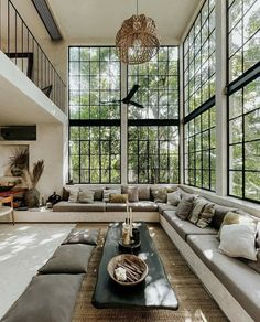 a living room filled with lots of furniture and windows