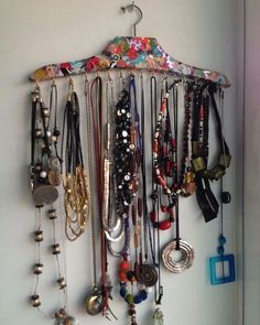 a bunch of necklaces hanging on a wall