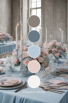 the table is set with candles, plates and flowers in shades of blue, pink, gray, and white