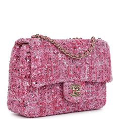 This Mini Rectangular Flap Bag is in pink tweed and sequin fabric with gold hardware and has a front flap with signature CC turnlock closure and an interwoven gold chain link and pink leather shoulder/crossbody strap.The interior is lined in pink leather and has one zip pocket with a logo pull.Collection: 24P Origin: FranceCondition: New and never worn (plastic on hardware)Accompanied by: Chanel box, Chanel dustbag, felt, carebook, retail UPCMeasurements: 8" width x 5" height x 2.5" depth; 22.5" strap drop Pink Chanel Backpack, Pink Chanel Bag, Dress Reference, Chanel Classic Flap Bag, Chanel Box, Chanel Backpack, Chanel Brand, Mini Classic, Classic Flap Bag