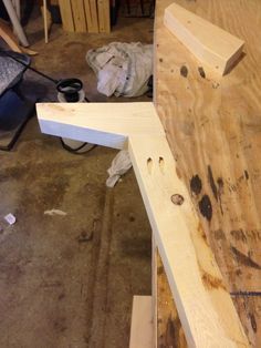 a wooden bench being built in a workshop with wood shavings on the floor