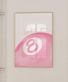 a pink painting hanging on the side of a white wall next to a window with an i love you sign above it