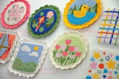 several embroidered coasters are arranged on a table