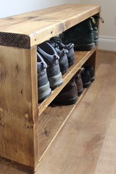 several pairs of shoes are lined up on a wooden shelf