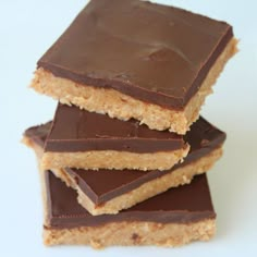 three pieces of chocolate peanut butter bars stacked on top of each other