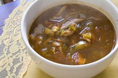 a white bowl filled with soup on top of a table